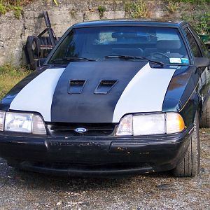 The hood rebuild in primer and mocked up on the car