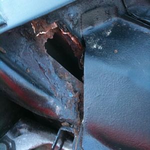 close up of the hole under pass side of windshield