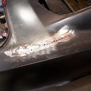 Replacing right side quarter.  Melting the old lead from the seam.