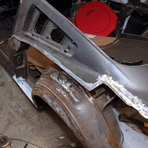 Left Side Quarter - old repairs, missing metal, and rot made a good case for replacing the whole quarter.