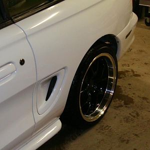 18x10 rears, 275 tire, small ding and crack above tire, possibly from previous body work?