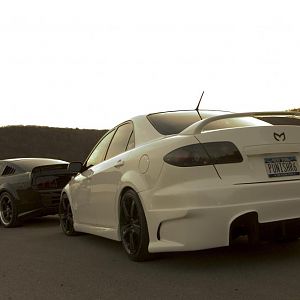 Mazda and Mustang behind