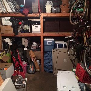 coolers stacked on top of snowblower, tables to be moved on right side of garage. empty shelf to be used for stuff on floor. To be organized by the en